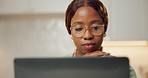 Woman, glasses and remote work in home with laptop, thinking and reading proposal for blog post. Black person, browsing and freelance writer in house with computer, planning and article for website.