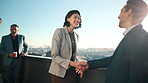 Business, partnership or people on balcony with handshake, greeting or negotiation in b2b deal. Networking, flare or employees at office with shaking hands, agreement or opportunity in collaboration.