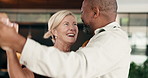 Dancing, smile and couple in home with music for bonding, love and safety in marriage on weekend. Happy, interracial people and mature man with woman for moving to playlist, radio or album in house.