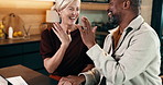 Happy, couple and finance with high five in home for winning, success or good news together. Interracial relationship, man and woman with smile or touch for achievement or accomplishment in house