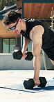 Breathing, dumbbells and fitness with man outdoor for health, training or workout routine. Exercise, shades and weightlifting with strong person on concrete porch of home for bodybuilding session