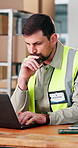 Man, thinking and logistics in warehouse with laptop, track delivery status or typing email to courier. Supply chain, person and problem solving with computer, check export report or shipping update.