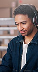 Man, logistics and headphones in warehouse with smile, reading and streaming music for delivery. Happy, person or dancing at small business with audio, listening to podcast and ecommerce distribution