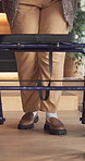 Legs, woman and walking at house with walker, mobility and balance support for rehabilitation. Feet, rollator and female person with disability, injury recovery and movement aid for physical therapy