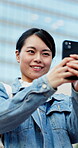 Woman, phone and photography in city with travel, memory or recording for social media post. Adventure, exploring and happy Asian person with mobile app, picture taking or live streaming in Japan