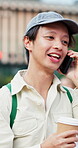 Man, phone call and walking in city for travel with coffee, smile and sightseeing with communication about trip. Male person, happy and mobile conversation with drink, contact and network in Japan