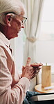 Senior man, praying and bible in home, religion and worship with holy scripture or spiritual belief. Praise, God and pensioner with book for Christianity, knowledge and Jesus Christ guidance in house