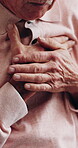 Chest pain, old man and hands in home with massage, hypertension and symptom of cardiac arrest. Senior person, retirement and worry in house with heartburn, chronic illness or cardiovascular issue