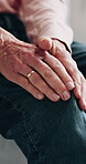 Knee pain, hands and elderly person in home with muscle ache, inflammation and massage for relief. Old man, leg and joint injury in house with arthritis symptoms, gout complication and discomfort