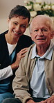 Assisted living, face and nurse hugging old man in retirement home for elderly care o r support. Happy, healthcare and insurance with caregiver embracing senior patient in apartment for wellness