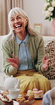 Senior woman, laughing and tea party in home, connection and discussion with friends in living room. Happy, mature person and funny conversation with coffee, gossip and relax with dessert in house