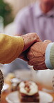 Friends, house and old people holding hands to pray in elderly club for support, grace and tea party. Retirement home, community and connection with senior circle, group or love and prayer for meal