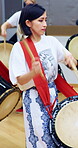 Music, woman or group with taiko drums in studio for performance practice, coordination or culture. Talent, asian female band or drummer with bachi for percussion, festival rehearsal or learning beat