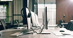 Office, equipment and computer with headset in call center agency for virtual assistance. Empty, space and technology with lens flare or help desk for business operations or startup in workplace