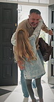 Door, home and child running to dad for hug, welcome and greeting for arrival or return from work. Happy man, girl kid or daughter in family house with love, care or reunion with safety and security