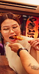 Man, feeding and asian woman with skewer for japanese cuisine, travel or recipe together. Female person, stick or eating with kebab, dango or street food for meal, snack or dining in town market