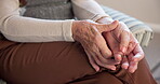 Arthritis, hands and senior person on sofa in living room of home for symptoms of chronic condition. Carpal tunnel, fibromyalgia and wrist pain with old woman in apartment for health or retirement