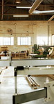 Empty, workshop and wood with machinery for carpentry, furniture restoration and lumber manufacturing. Factory, hardware and timber with gear for woodwork project, production and industrial business.