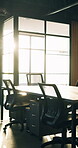 Business, empty and desk in office with flare, coworking furniture and window in professional space. Vacant, corporate and modern chairs in workplace, decor setup and networking area in workspace.