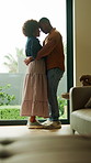 Happy, couple and hug in home with dance, singing song or connection for bonding together on weekend. Black people, dating and embrace in lounge with love, romantic relationship and rhythm to music.