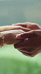 Care, holding hands and love with couple outdoor together for commitment, empathy or support. Comfort, relationship and sympathy with people in garden for consoling, security or trust closeup