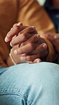 Couple, holding hands and relax in home with love, emotional support or security in relationship. Commitment, people and together in house with trust, loyalty or bonding with connection in solidarity