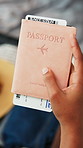 Hand, travel and passport with ticket in home, documentation and luggage for holiday preparation. Person, boarding pass and identity book for international trip, flight and vacation in bedroom