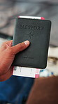 Hand, holiday and passport with ticket in home, documentation and luggage for travel preparation. Person, boarding pass and identity book for international trip, flight and vacation in bedroom