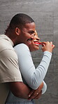 Couple, hug and brushing teeth in bathroom, bonding and laugh with partner in house or oral hygiene. Black people, grooming and happy with spouse in home, morning routine and dental care for mouth