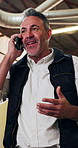Phone call, walking and carpenter in workshop for communication on furniture manufacturing with order. Man, cellphone and mature woodworker on mobile discussion for feedback on industrial project.