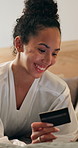 Credit card, check and woman on bed with phone, online banking and payment in eft transaction. Fintech, happy and person in house with tech, easy purchase and debit details for cashless service.