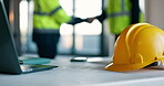 Civil engineering, laptop and helmet on table in office, collaboration or shaking hands for project. Architect, handshake and people with agreement, discussion and teamwork for property development