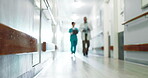 Blurry, hallway and medical team with documents in hospital, discussion or ideas for treatment plan. Clinic, colleagues and people with paperwork, conversation and information for healthcare service