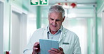 Tablet, man and doctor in hospital with research for diagnosis information, treatment or telehealth. Digital technology, reading and mature healthcare worker with medical information in clinic.