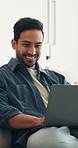 Creative, freelancer and happy man with laptop in lounge, graphic designer or brand identity on web. Remote work, online and person with technology for logo design, typography and assignment in house