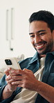 Laugh, text and man on couch with phone, digital communication and comic post on social media. Contact, typing and happy person in house with tech, funny message and meme reaction on chat app.