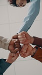 Group, fist bump and celebration with team in office, success or motivation for marketing assignment. People, hands and solidarity with colleagues, low angle and cheering in advertising agency