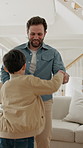 Family, dancing and home with children for music, bonding or playful vibe together in living room. Mom, dad and happy kids holding hands with movement for audio streaming, energy or holiday in house