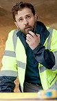 Man, engineer and radio at construction site for inspection, talk and report for property expansion. Person, architect and tech for communication with real estate development, safety check or contact