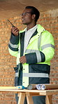 Architect, talking and black man with radio for conversation, building instructions or planning. Male person, civil engineer or contractor with signal or channel for construction discussion on site