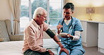 Blood pressure, home and nurse with old man for healthcare exam, talking or machine. Retirement, female caregiver and senior person with patient care, hypertension and vitals for heart wellness