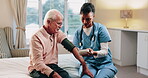 Blood pressure, home and caregiver with old man for healthcare exam, talking or machine. Retirement, female nurse and senior person with patient care, hypertension and vitals for heart wellness