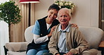 Face, caregiver and old man in retirement home with support, smile and healthcare for rehabilitation. Happy, nurse and elderly person on couch with assisted living, kindness and medical assistance.