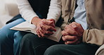 Hands, bible and people in home with prayer, study and Christian faith with volunteer in living room. Senior person, caregiver and scripture for spiritual knowledge, wisdom or support in retirement