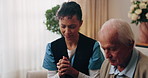 Caregiver, pray and old man in retirement home with faith, Christian religion and ask God for healing. Nurse, senior person and worship Jesus in living room with hope, spiritual belief or connection.