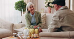 Talking, tea and relax with old people on sofa in home for chat, connection or brunch visit. Social gathering, reunion and retirement with senior friends in living room of apartment for dessert