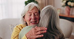 Happy, old woman and friends at house with hug, welcome and bonding together for reunion. Smile, senior people and talking in lounge with embrace, friendly affection and compassion for weekend visit