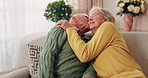 Senior couple, hug and kiss in home with love, care or discussion together in happy marriage in living room. Elderly man, old woman and chat or conversation for retirement, affection and embrace