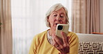 Video call, online and senior woman with phone, smile and communication with contact on app in house. Elderly person, home and discussion on social media, retirement and happy for gossip on mobile