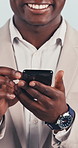 Businessman, hands and typing in studio with phone, text message and laugh for social media meme. Happy, African person and scroll with tech, work email and funny internet joke on white background.